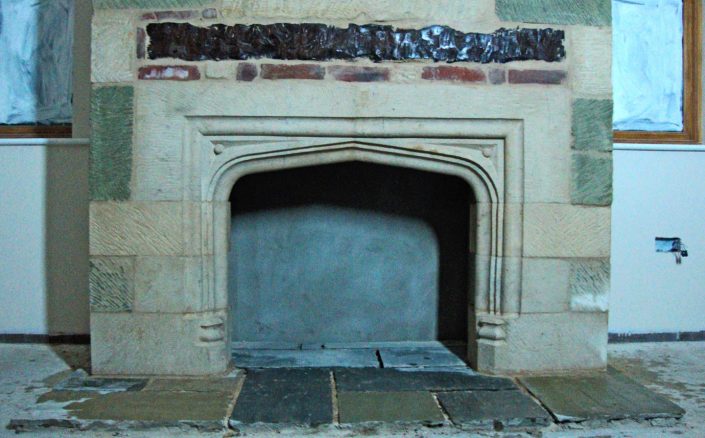 Inset Bathstone Fireplace with Greensand and Bathstone quoins around a modern Chimney breast