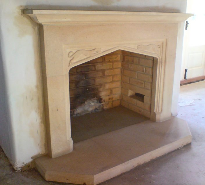 Large Bathstone fireplace with running hounds in spandrels
