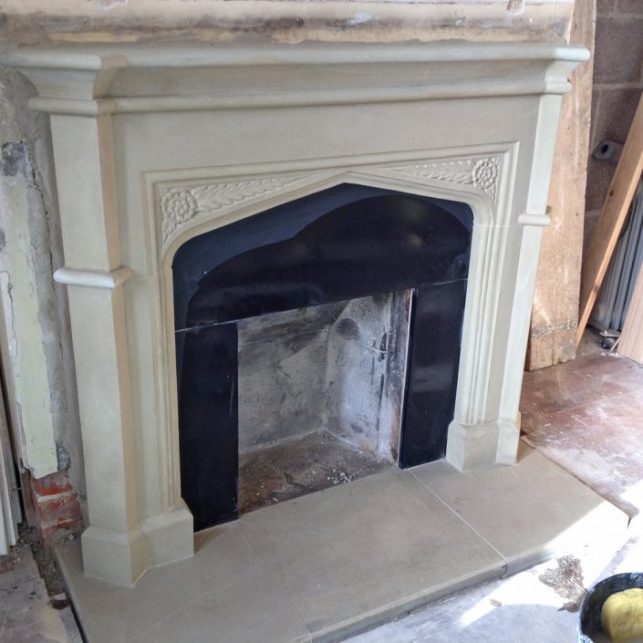 Pillaster sided Fireplace with roses in spandrels Chicksgrove stone